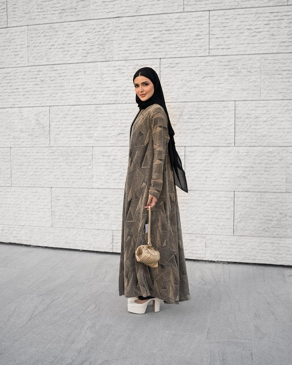 Geometric patterned abaya styled outdoors