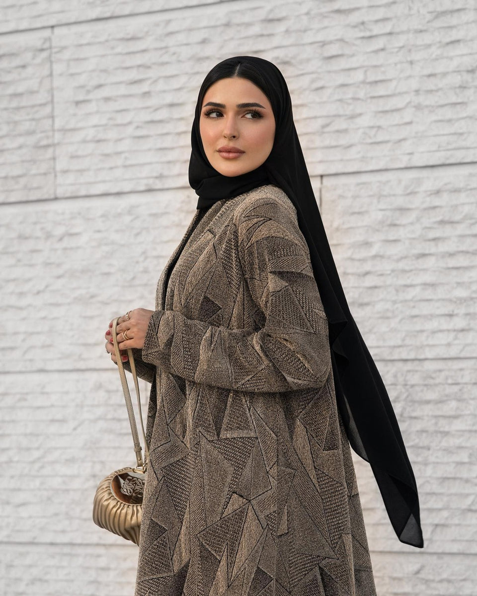 Close detail of geometric patterned abaya