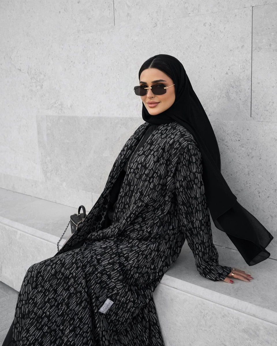 Black patterned abaya styled outdoors